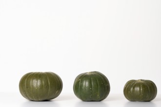 Three green pumpkins isolated on a white background