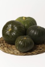 Green pumpkins cut in half on wood and white background