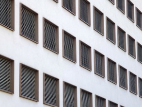 Modern building view with regular window arrangements and ventilation grilles in minimalist