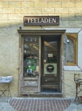 Entrance to a small, cosy tea shop in an old town with decorative shop window Mödling Lower Austria