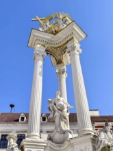 Magnificent monument with columns and statues under a bright blue sky Trinity Column Old Town Krems