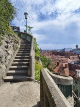 Stone steps lead to a vantage point with a view of the city of Graz Styria Austria