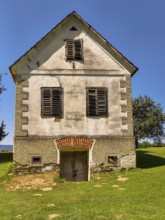 Old house with cracks and closed shutters in a meadow Styria Austria