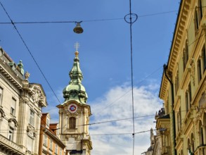 Historic architecture on a busy street with visible power lines Herz Jesu Kirche Graz Styria