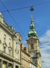 Historic building with green tower under a clear, sunny sky Herz Jesu Kirche Graz Styria Austria