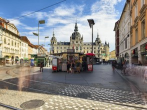 Lively town square with urban buildings and moving people Landhaus Graz Styria Austria