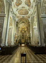 Magnificently decorated baroque interior with altar and ceiling frescoes, atmospheric play of