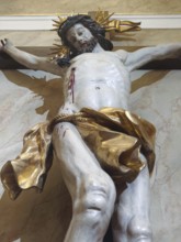 Dramatic depiction of Jesus Christ on the cross with golden elements in baroque style,