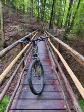 Mountain bike standing on a narrow wooden bridge in the forest Styria Austria