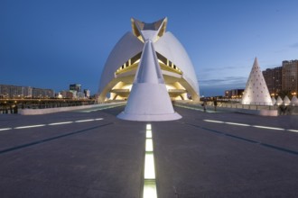 Symmetrical view of a modern building at dusk with illuminated path Opera