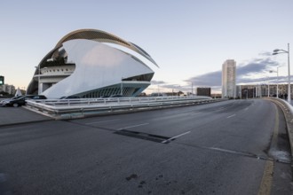 Futuristic building next to a street under a cloudy sky Opera