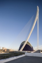Large modern bridge next to futuristic blue building