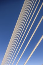 Close-up of cables of a bridge against a clear blue sky