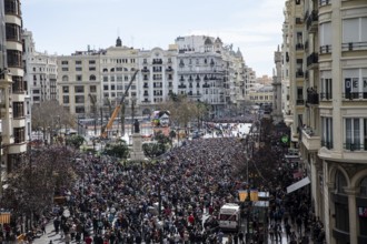 Large crowd in the city centre with tall buildings in the background MascletÃ¡ de Fallas