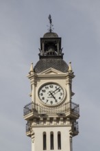 A historic clock tower with detailed architecture against a clear sky