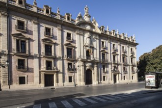 Baroque building with imposing faÃ§ade on an empty street under a blue sky