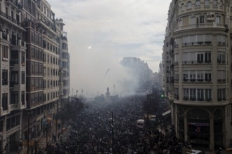 Protesting crowds move through a smoky city centre MascletÃ¡ de Fallas
