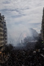 Large crowds in the city with billows of smoke and urban background MascletÃ¡ de Fallas