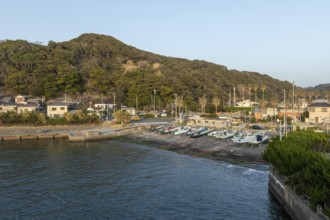Boats in the evening light and mountain landscape in the harbour of Hamakanaya, Futtsu, Chiba