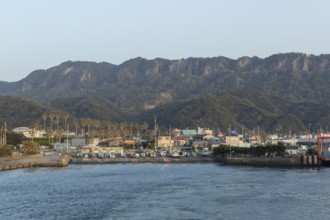Boats in the evening light and mountain landscape in the harbour of Hamakanaya, Futtsu, Chiba