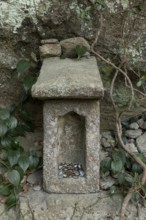 Small stone house for offerings with yen coins on the Shariki-michi Trail to Mount Nokogiri, Mount