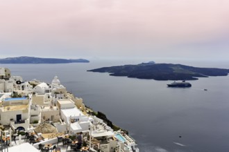 View from the island capital Fira to the uninhabited volcanic island Nea Kameni in the caldera,