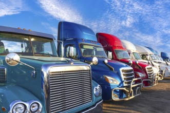 Long haul container trucks carrying commercial cargo on a parking lot ready for delivery