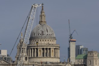 Dome of St. Pauls cathedral and mechanical cranes, City of London, England, United Kingdom
