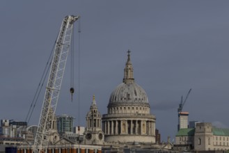 Dome of St. Pauls cathedral and mechanical cranes, City of London, England, United Kingdom