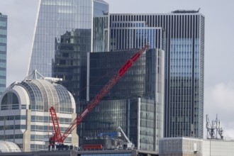 Mechanical red crane on a building, City of London, England, United Kingdom