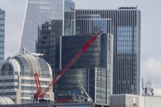Mechanical red crane on a building, City of London, England, United Kingdom