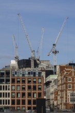 Mechanical cranes on buildings, City of London, England, United Kingdom