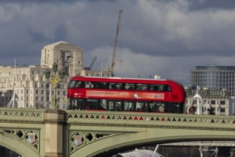 Red double decker bus driving over a bridge, City of London, England, United Kingdom