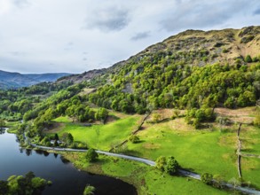 Farms and Mountains over road A591 from a drone, Grasmere Lake, Grasmere, Ambleside, Lake District,