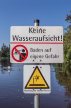 Warning sign, no water supervision, bathing at your own risk in the ArgenbÃ¼hl moor pool near