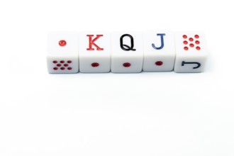 Four white dice forming the poker hand king, queen, jack, lying on a white background, ideal for
