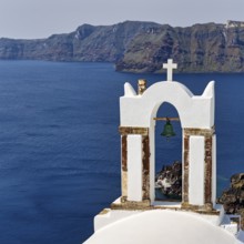 Bell tower of an orthodox church with a view of the caldera, Oia, Santorini, Cyclades, Greece