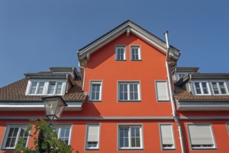Red pointed gable facade with dormers, blue sky, Isny, Swabia, Baden-WÃ¼rttemberg, Germany