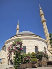 Kemer city centrum view of grand mosque Huzur Camii Dzamija with two minarets and dome. Beautiful