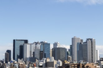 Modern architecture, view over the rooftops of the city to the glass facades of skyscrapers against