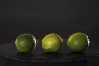 Three limes on a stone slab
