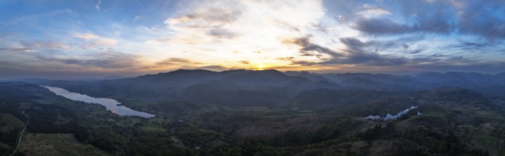 Panorama of Sunset over Mountains and Coniston Water from drone, Lake District National Park,
