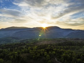 Sunset over Mountains and Coniston Water from drone, Lake District National Park, Cumbria, England,