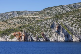 View from the sea to the red rocks, island of Hvar, Dalmatia, Croatia