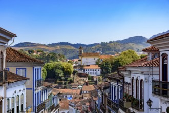 Houses and church in the historic city of Ouro Preto with the mountains in the background, Ouro