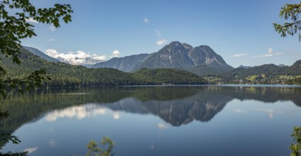 Peaceful lake surface with mountain panorama, Dachstein and Sarstein, cloud reflection in the