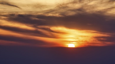 Sunset behind clouds, blurred, Oia, Thira, Santorini, Cyclades, Greece