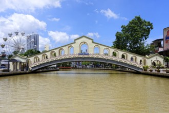 Jambatan Old Bus Station Bridge on the Malacca or Melaka river and the Ferris Whell of the Theme