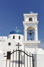 White, orthodox church of Agios Anastasios with blue dome and bell tower, Imerovigli, Thira,
