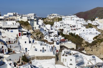 Typical white architecture on a hillside, cave dwellings, holiday flats, stairs, narrow alleyways,